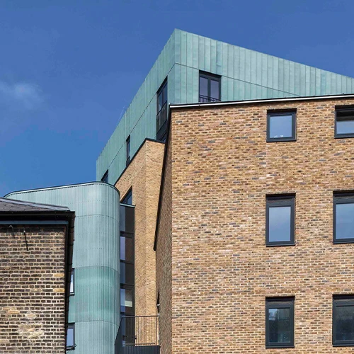 ram_quarter_exterior_green_copper_walls_aurubis__behind_brick_buildings